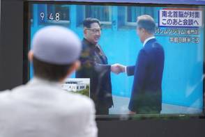 Un hombre en Tokyo observa el histórico encuentro. (AP Photo/Eugene Hoshiko)